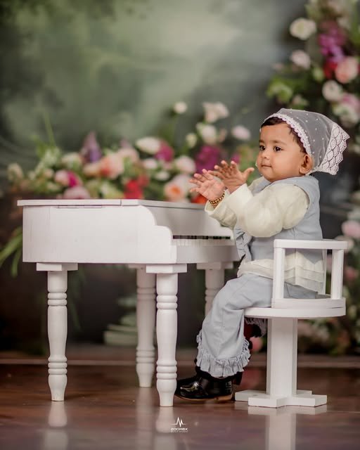 Indoor studio photoshoot with a baby at a toy piano